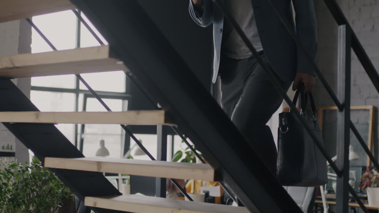 Businessman Walking Upstairs in Modern Office