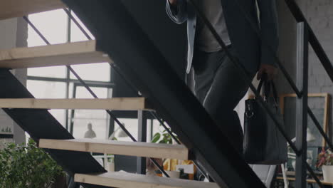businessman walking upstairs in modern office