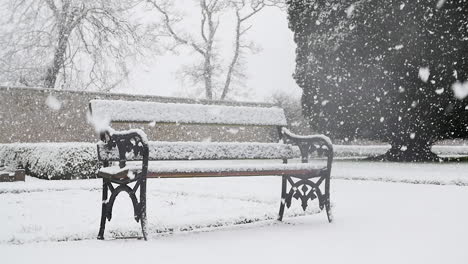 park bench heavy snowfall in winter