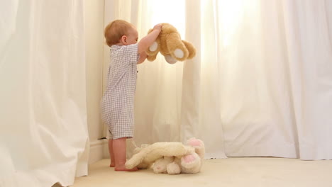 little boy playing with teddy bears