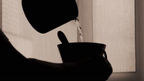 silhouette shadow of cup kitchen ware pouring water into a mug in slow motion