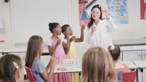 Focused-diverse-female-teacher-and-elementary-school-schoolgirls-in-lab-in-slow-motion