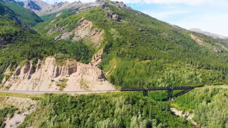 4K-Drone-Video-of-Trail-Trestle-bridge-along-Chulitna-River-near-Denali-National-Park-and-Preserve,-AK-during-Summer