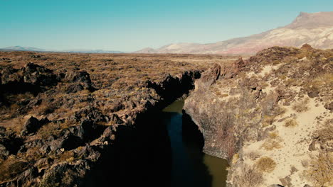 Drone-ascending-and-unveiling-the-canyons-of-volcanic-formations-at-"La-Pasarela,"-revealing-a-mesmerizing-landscape-of-geological-wonders