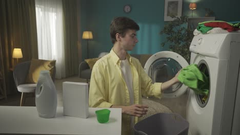 young man doing laundry