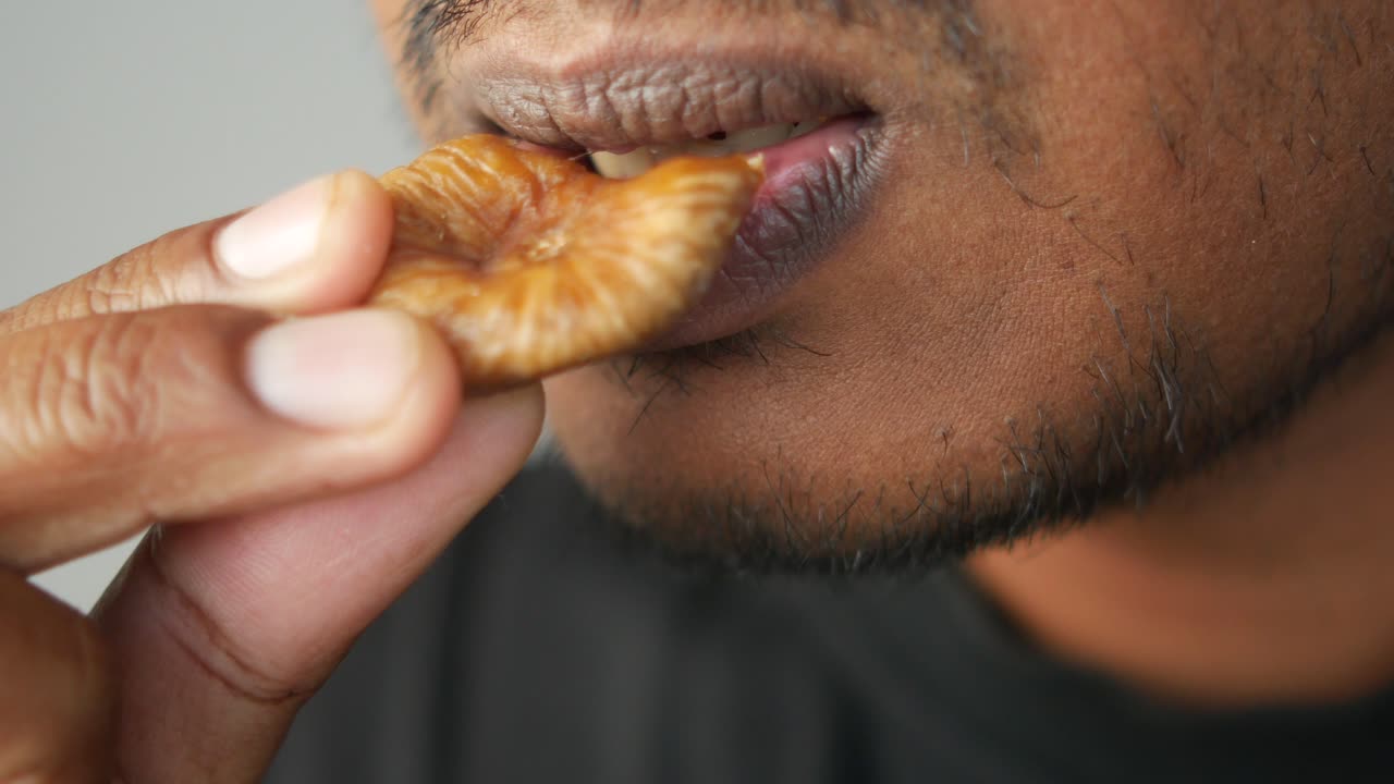 A person eating a fig