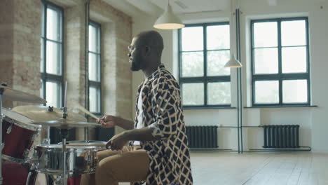 black drummer rehearsing in studio
