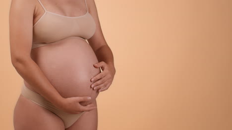pregnant woman touching her belly