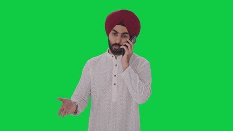 angry sikh indian man shouting on someone on phone green screen