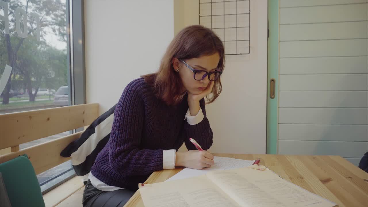 Teenage Girl Studying in a Cafe