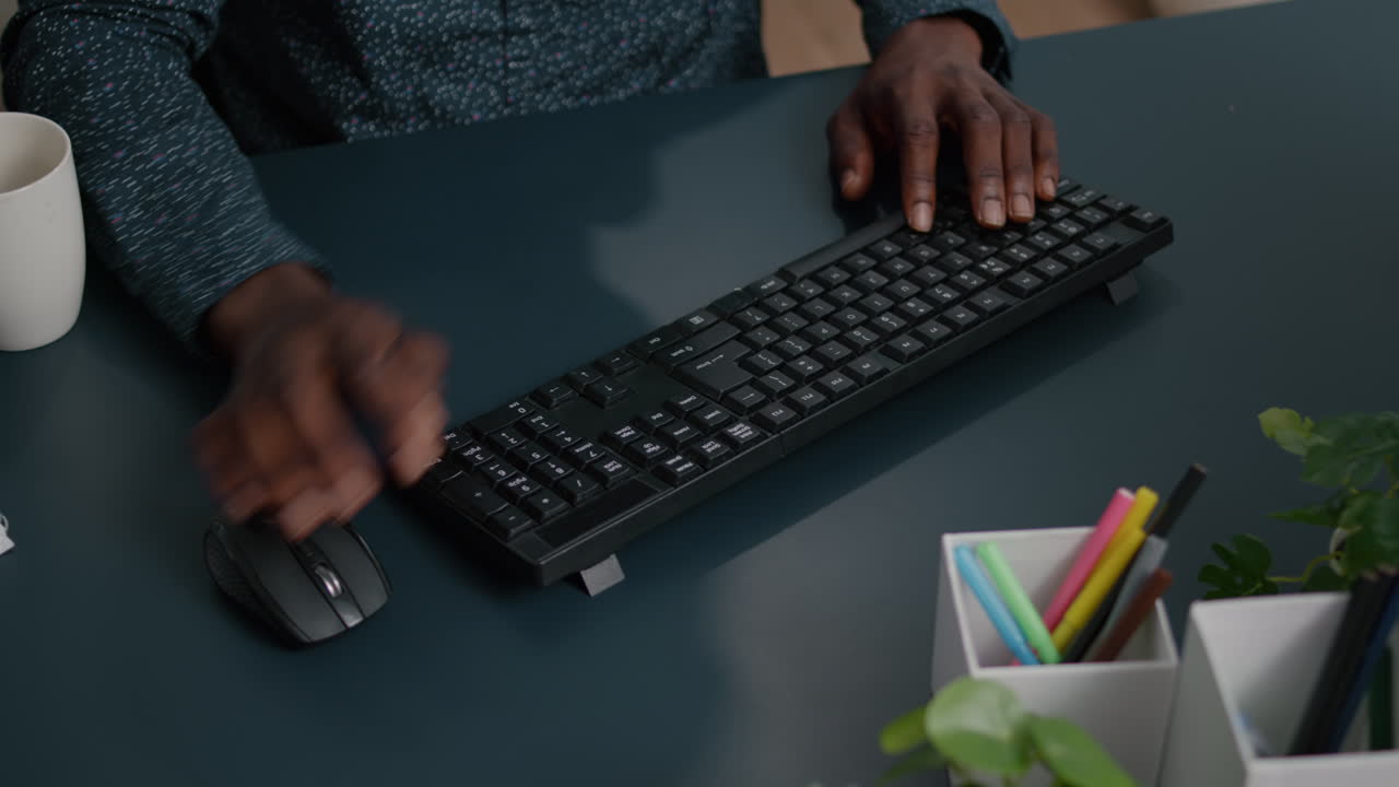 Black african american person typing on PC keyboard