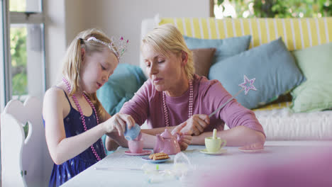 Caucasian-woman-playing-with-her-daughter-at-home