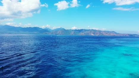 Aerial-panorama,-island-in-the-pacific-ocean-with-palm-trees-surrounded-by-turquoise-crystal-clear-waters-Thailand