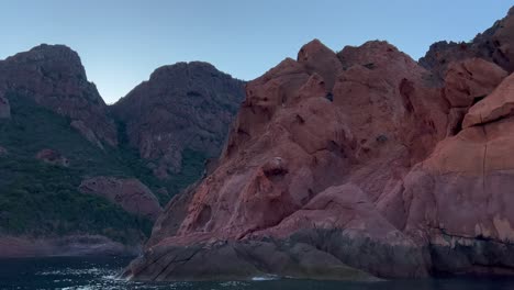 rocas rojas erosionadas de la reserva natural de scandola de la unesco vistas desde un barco de vela en la temporada de verano, isla de córcega en francia