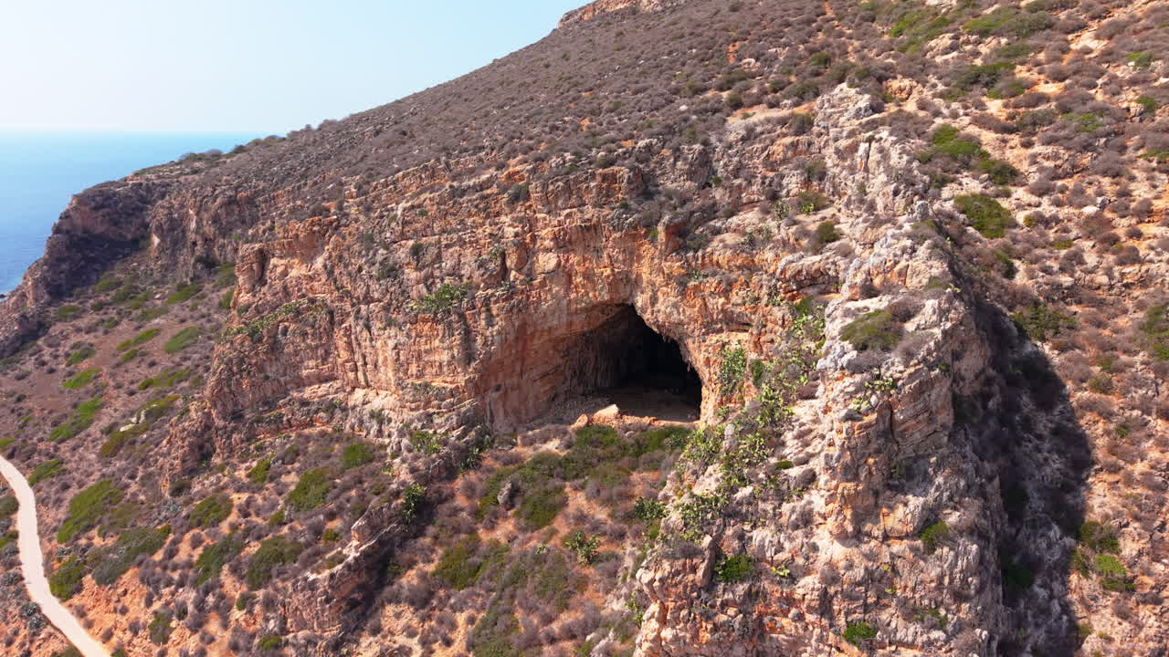 Aerial view of rocky cliff cave in Sicily, Italy, serene and natural