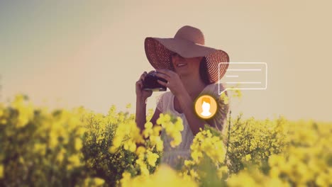 Animation-of-media-icon-over-caucasian-woman-taking-photo-on-field