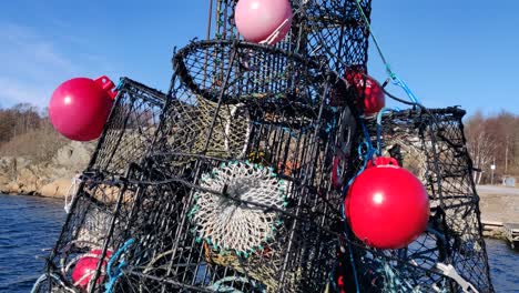 close-up tilt of coastal lobster cage next to the sea