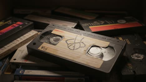 a compelling glimpse into nostalgia: a close-up of vintage vhs tapes captured in a stacked collection, highlighting the charm of analog media