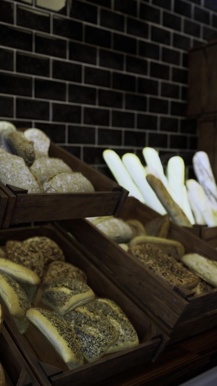 Bakery display of different types of bread arranged on wooden shelves in town