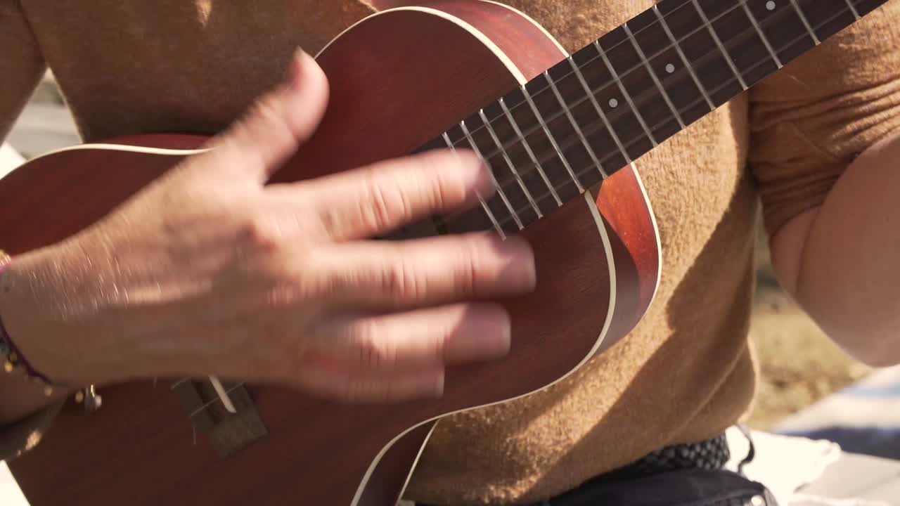 Ukulele playing and practicing, frontal shot