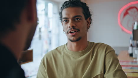 two colleagues meeting cafe discussing work closeup.  man talking to friend