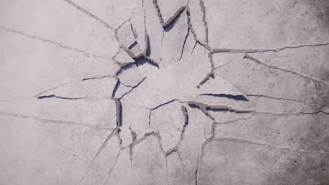 stone or concrete surface shatters and breaks from the center, revealing a dark void. dynamic ground breaking or wall destruction effect perfect for a dramatic transition or opener