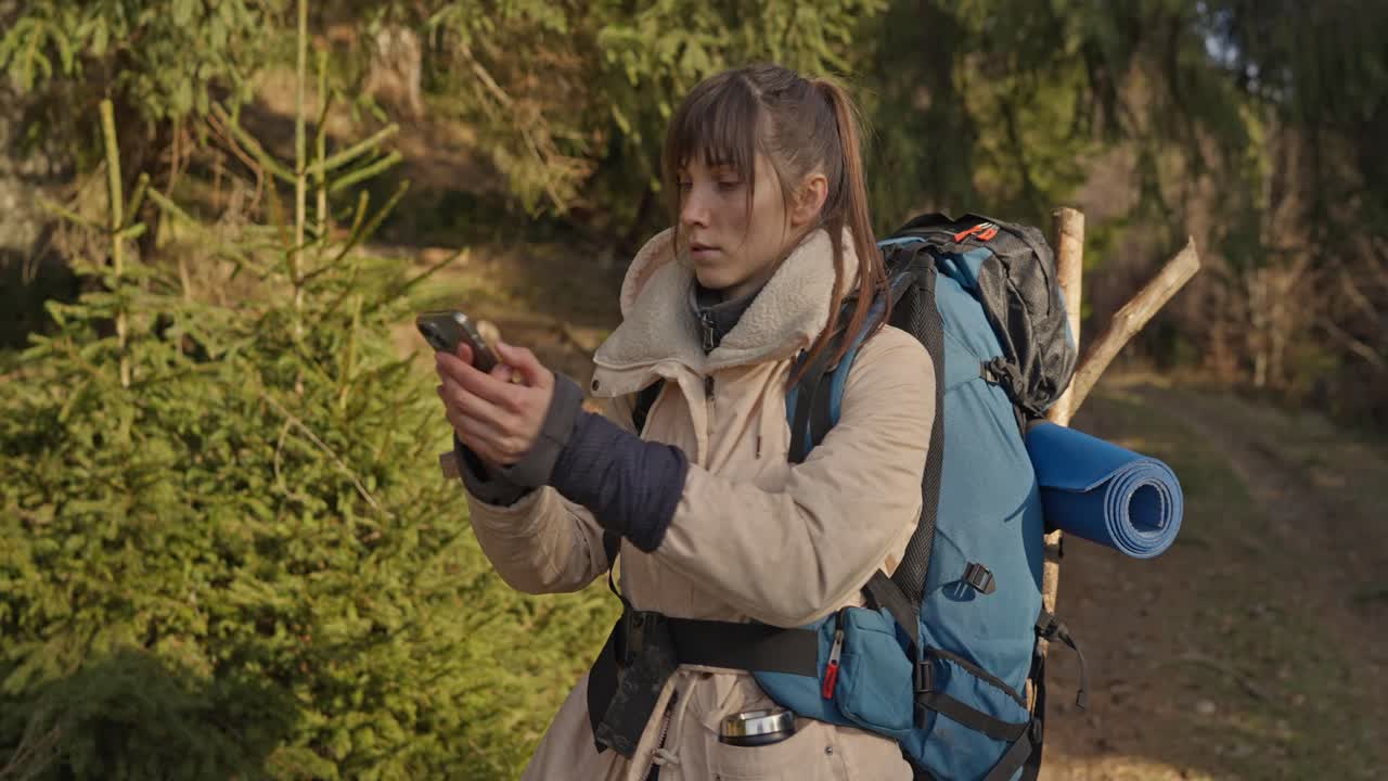 Woman hiking in forest with backpack