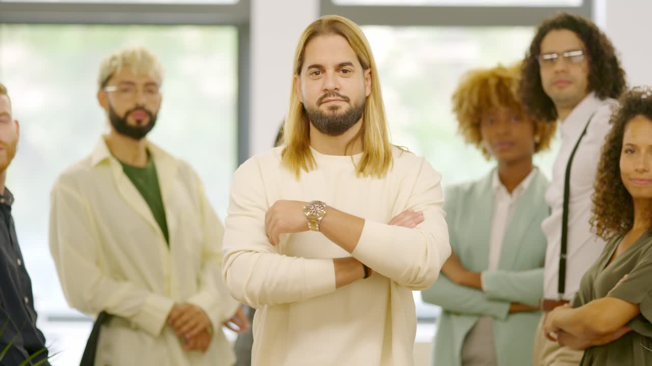 Man leading a group of coworkers standing proud