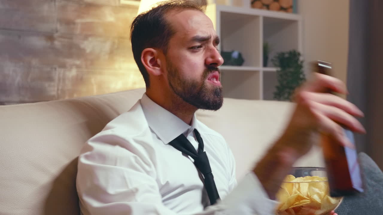 Businessman with a tie relaxing watching a comedy