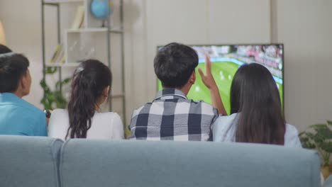 asian teenagers friends playing soccer video games at home and disappointed