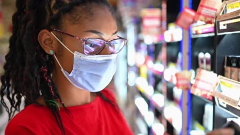 latin young woman wearing a face mask shopping make up