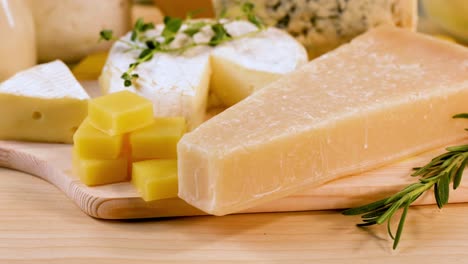 various cheeses and dairy items on wooden board