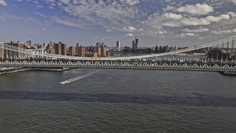nyc new york aerial v420 drone flyover manhattan bridge over east river capturing commuting traffics on the roadway and cityscape views of lower east side - shot with mavic 3 pro cine - september 2023