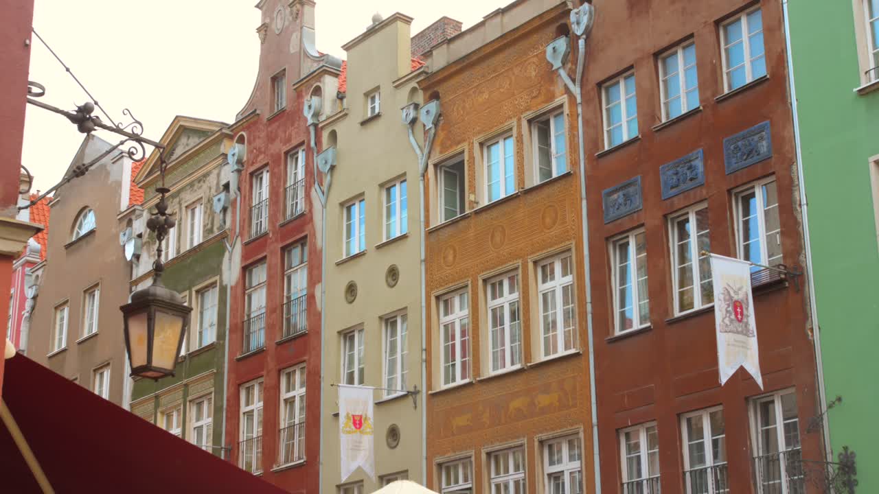 A street in the city of Gdansk with the old colorful houses in northern Poland.