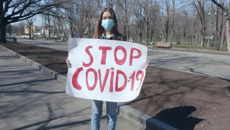 woman protesting against covid-19 in a park