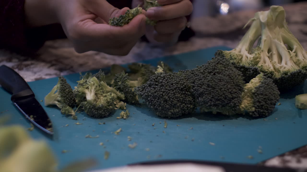Hands Female Chef Carefully Pulling Apart Broccoli Over Cutting Board