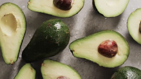 Micro-video-of-close-up-of-avocados-and-water-drops-with-copy-space