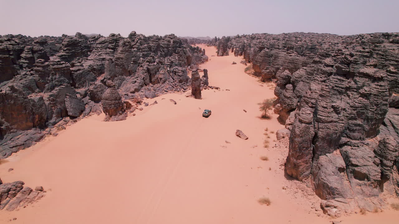 Vehicle Driving Off Road In The Desert In Tassili N'Ajjer National Park, Algeria - Aerial Drone Shot