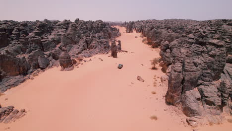 Vehicle Driving Off Road In The Desert In Tassili N&#039;Ajjer National Park, Algeria - Aerial Drone Shot