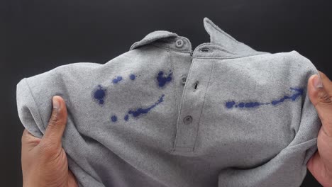 close-up of a grey shirt with blue ink stains