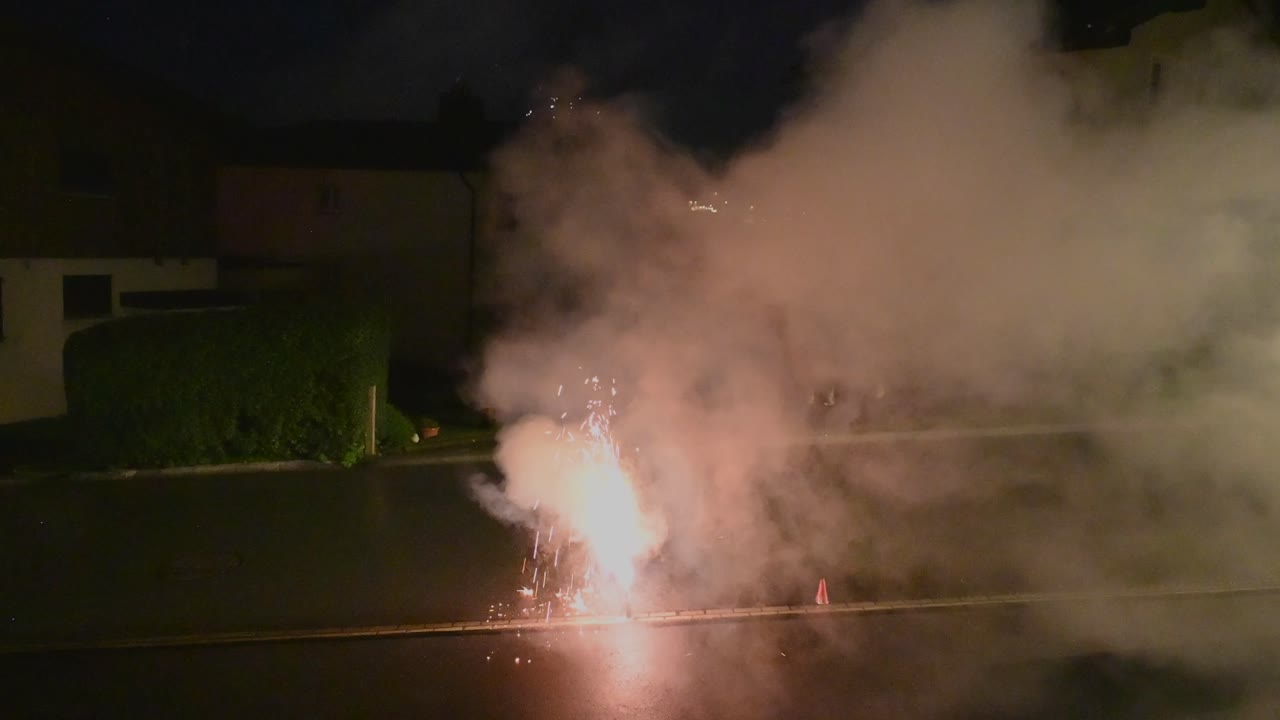 Blue and red smoke from a firework during a new year celebration at midnight