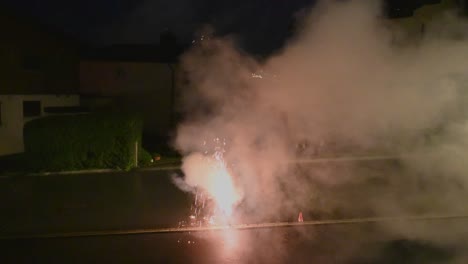 blue and red smoke from a firework during a new year celebration at midnight