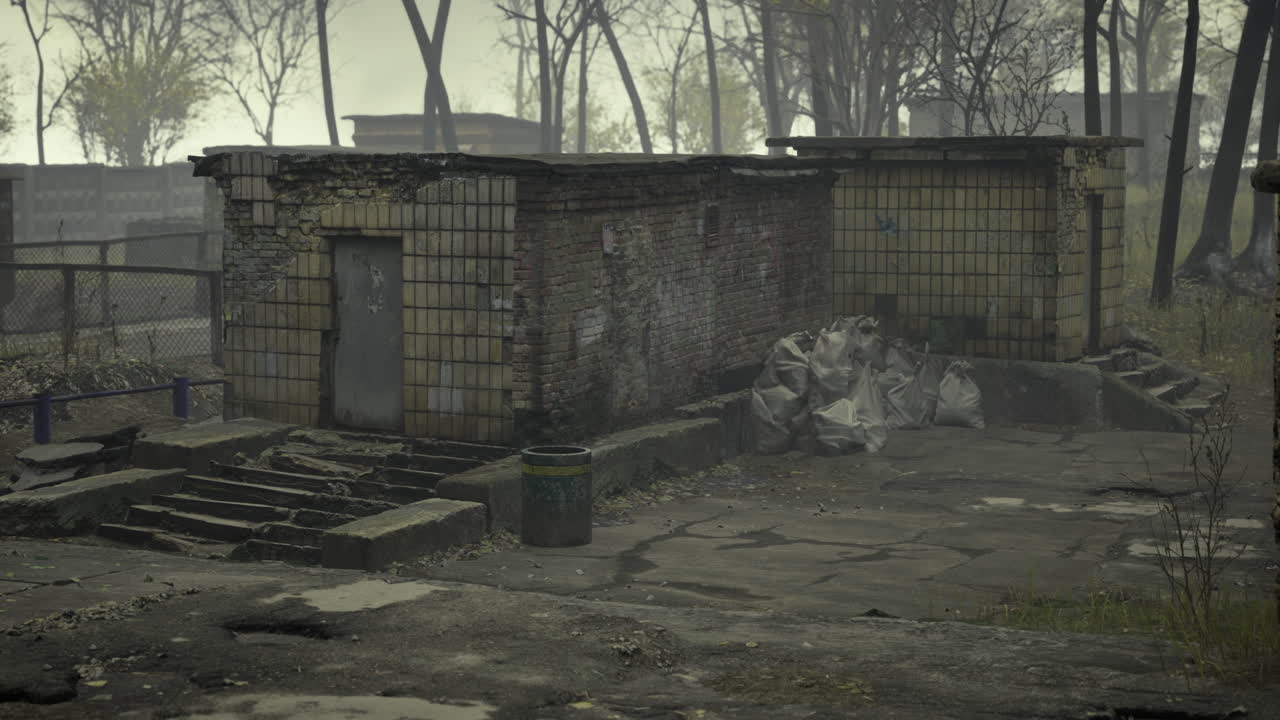 In a deserted area weathered buildings stand against a gloomy sky