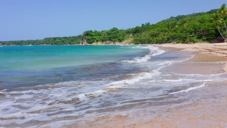 Small-Waves-Crash-from-the-Blue-Atlantic-Ocean-on-the-Incredible-Empty-Sandy-Beach-at-Playa-Preciosa-in-a-Tropical,-Luxurious,-Vacation-Landscape-in-the-Dominican-Republic