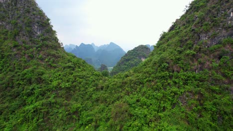 aerial dolly reveals mountainous landscape of moon hill or yueliang shan, yangshuo, china