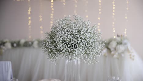 wedding table with gypsophila flowers compositions on center