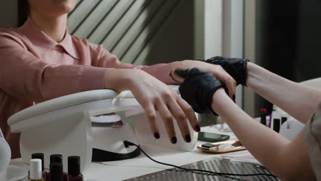 woman getting a manicure at a nail salon