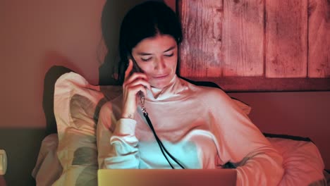 Caucasian-happy-woman-working-with-laptop-and-talking-on-cell-phone