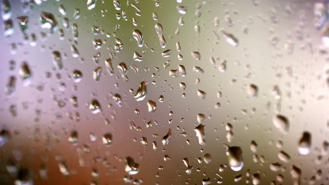 Drops on glass. Rain on glass window from indoors. Rain on glass. Raindrops of water on window background. Bad weather. Macro shot.