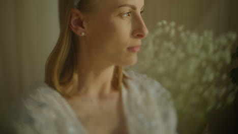contemplative woman with gypsophila bouquet